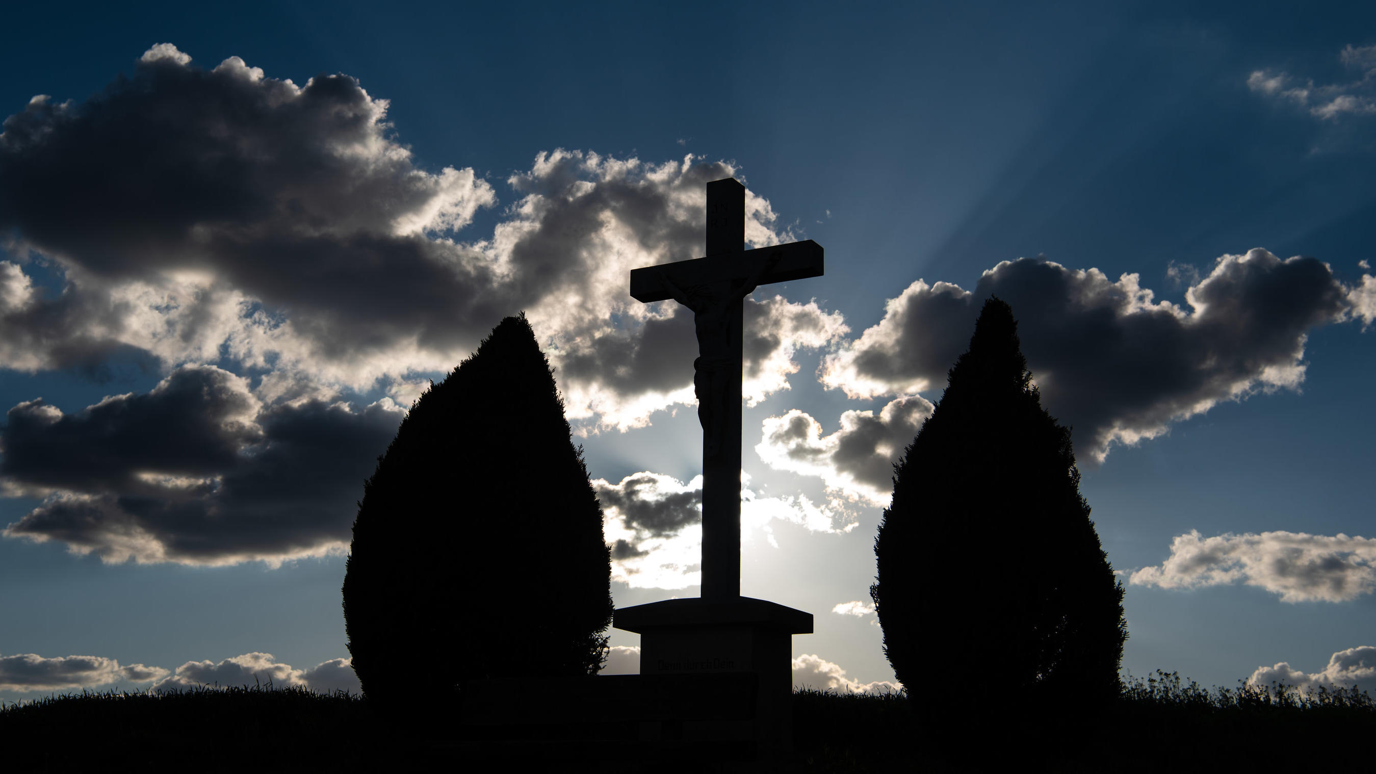 Das Wetter an Christi Himmelfahrt - Vorhersage für Vatertag und das lange Wochenende 12.05.2019, Bayern, Döringstadt: Ein christliches Kreuz ist als Silhouette vor dem Abendhimmel zu sehen. Foto: Nicolas Armer/dpa +++ dpa-Bildfunk +++