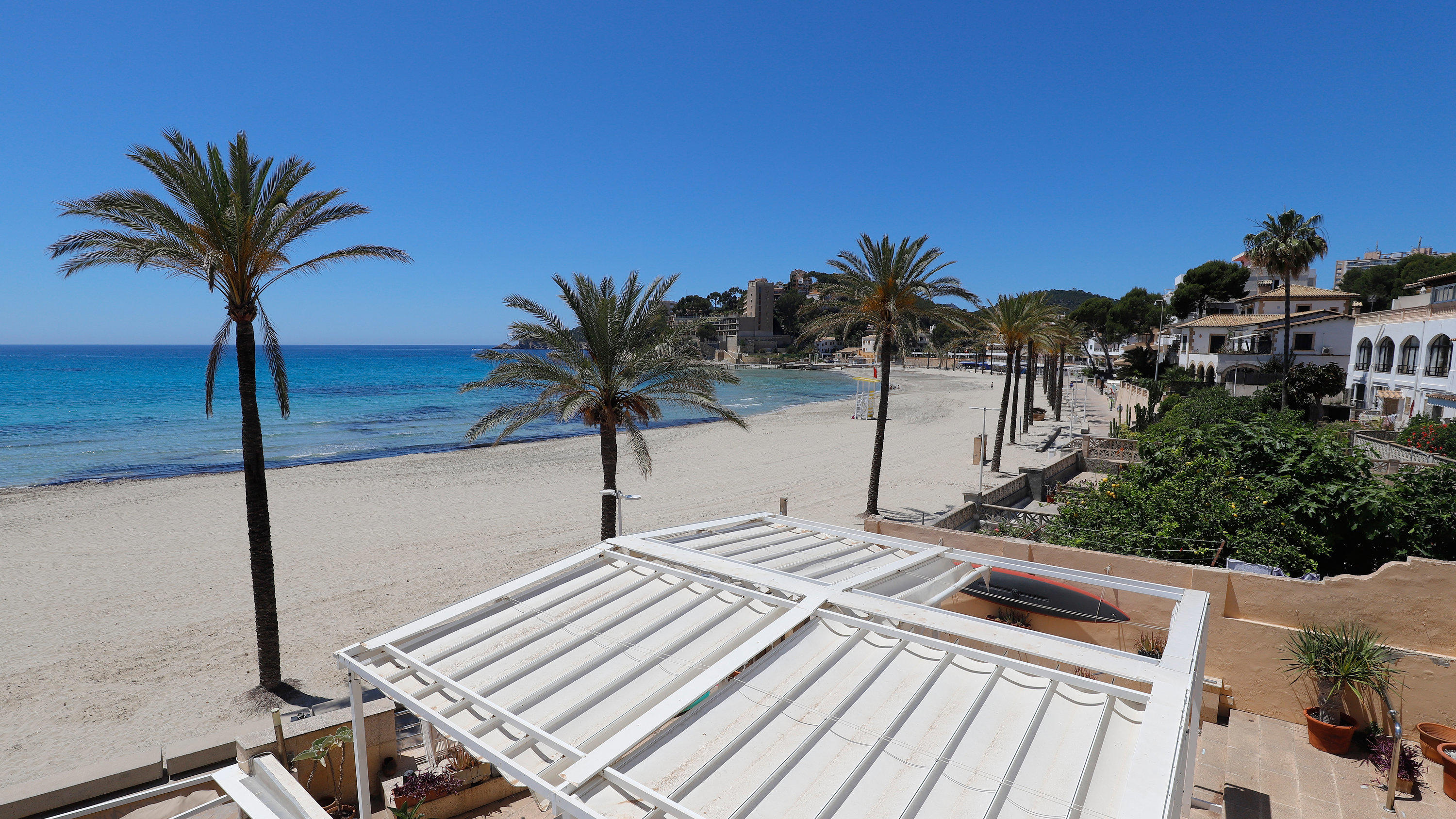 Mallorca empfängt ab 15. Juni über 10.000 deutsche Urlauber 20.05.2020, Spanien, Calvia: Der Strand von Paguera auf der spanischen Insel Mallorca ist leer. Einige spanische Provinzen dürfen in einer ersten Phase seit Ausbruch der Coronavirus (COVID-19) erste Sperrmaßnahmen lockern. Foto: Clara Margais/dpa +++