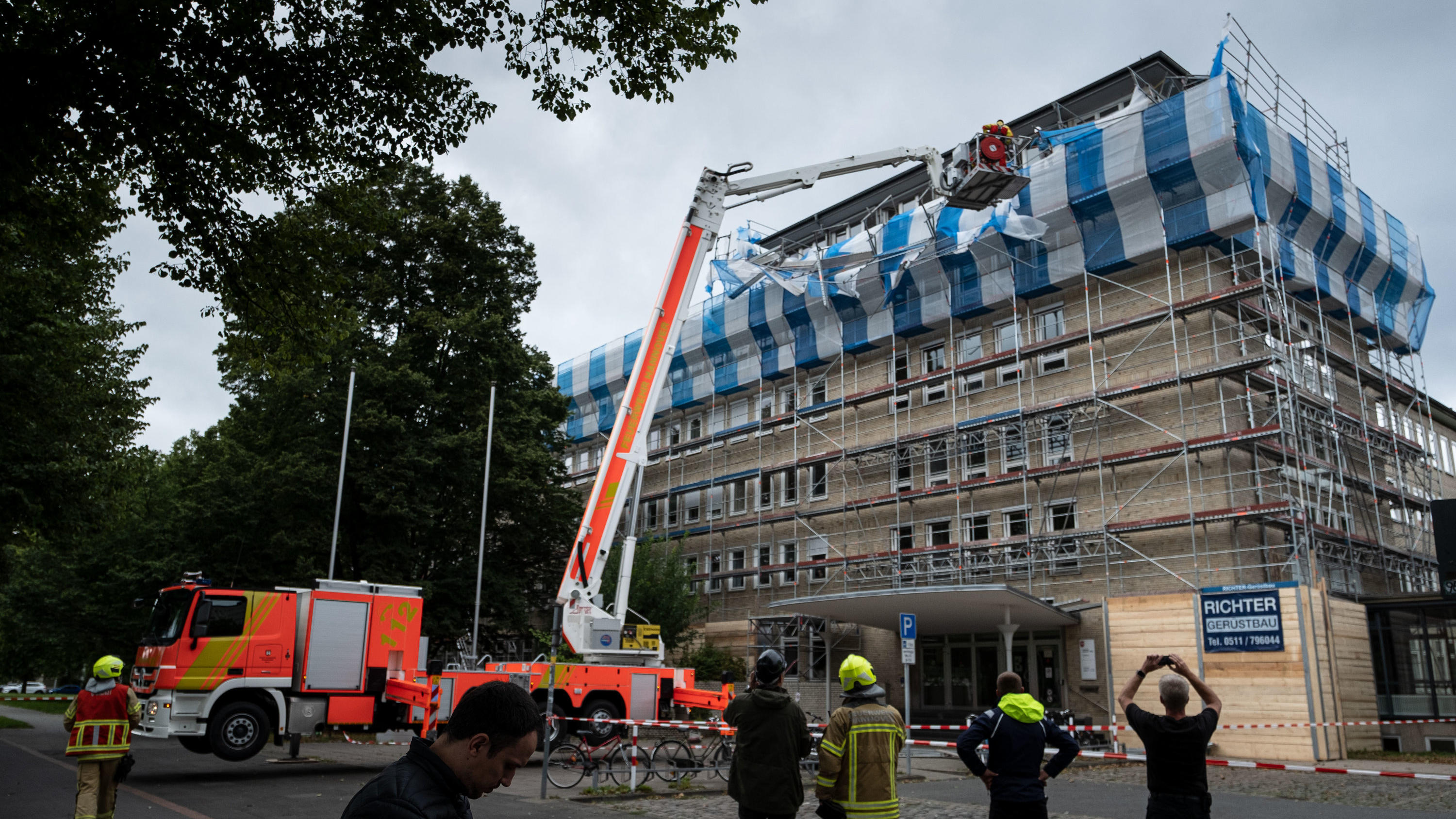 Sturm Kirsten: Das war der Live-Ticker 26.08.2020, Niedersachsen, Hannover: Feuerwehrmänner sichern ein Baugerüst auf dem Dach des Finanzamts in Hannover. Durch eine Sturmböe wurden Teile eines 20 Meter hohen Baugerüsts an der Fassade des Finanzamt-Mitte aus den Halterungen gedrückt. Foto