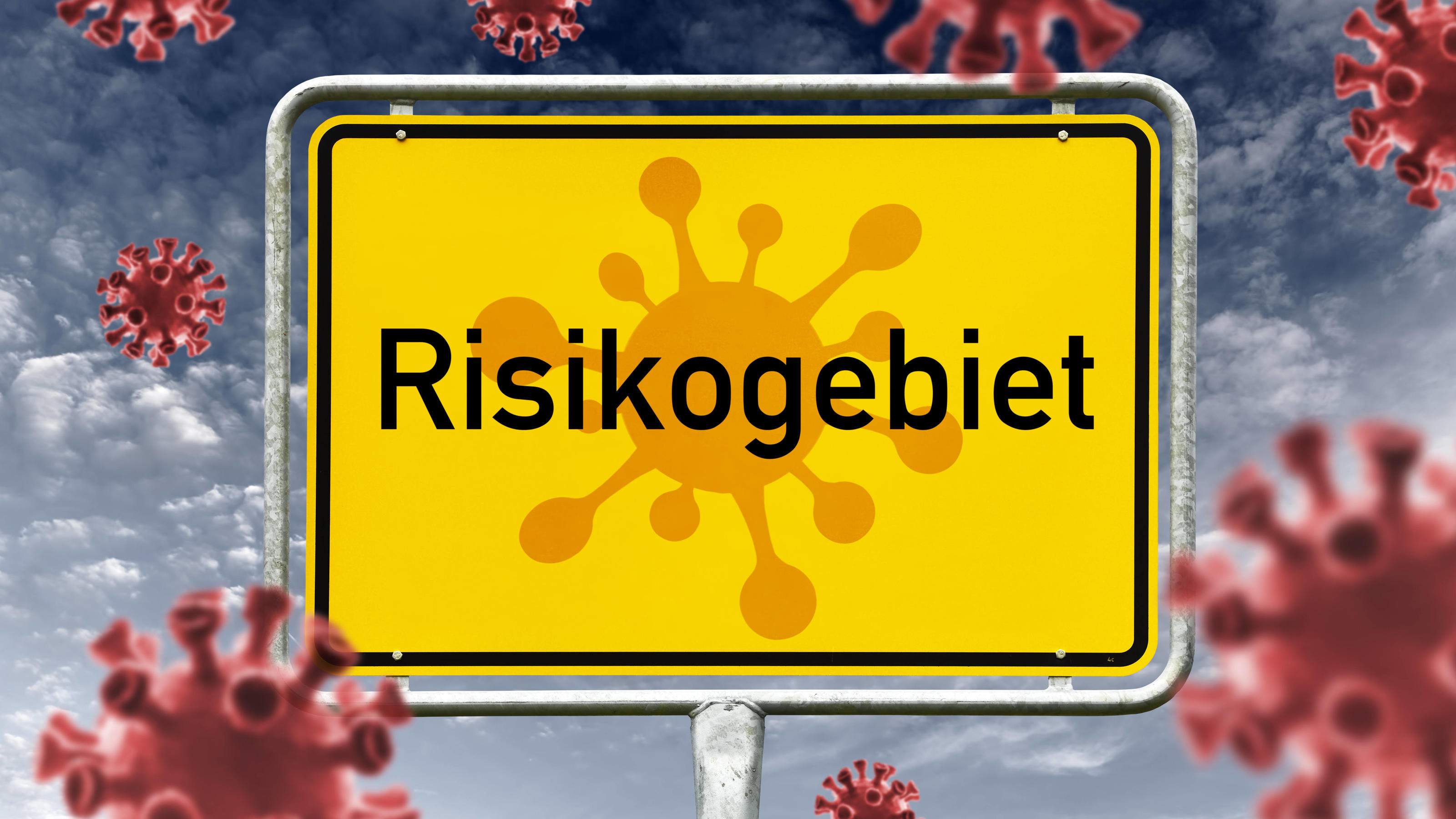 Interaktive Karte zu Corona-Neuinfektionen: So sieht es in Ihrer Region aus Ortsschild mit Aufschrift Risikogebiet und Coronaviren