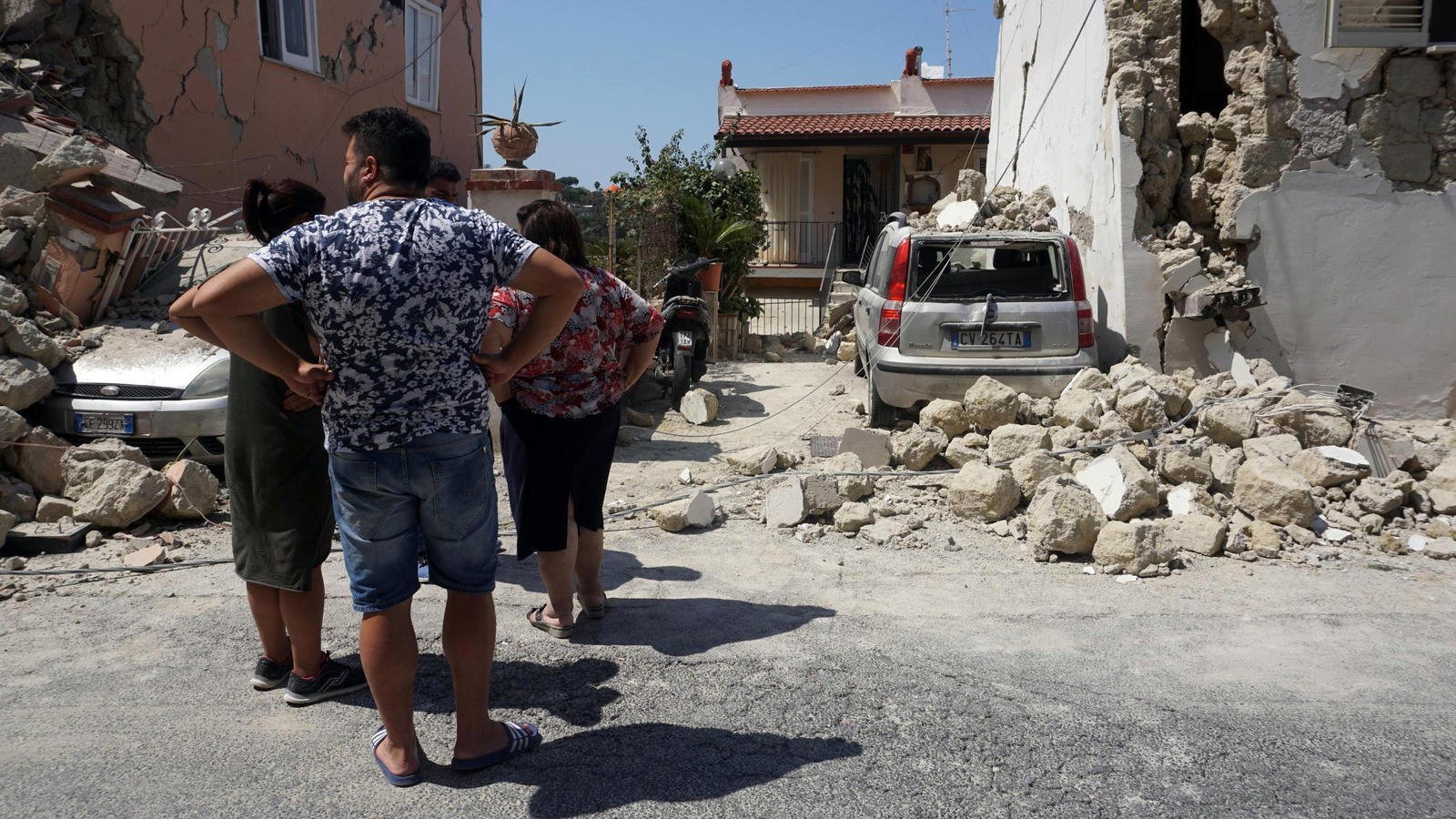 Tote und Verletzte bei Erdbeben in Italien: Junge (11) rettet seinem Bruder (7) das Leben Personen betrachten am 22.08.2017 auf der Urlaubsinsel Ischia (Italien) teilweise zerstörte Gebäude. Mitten in der Ferienzeit hatte ein Erdbeben die Urlaubsinsel erschüttert. Foto: Cesare Abbate/ANSA/AP/dpa +++(c) dpa - Bildfunk+++