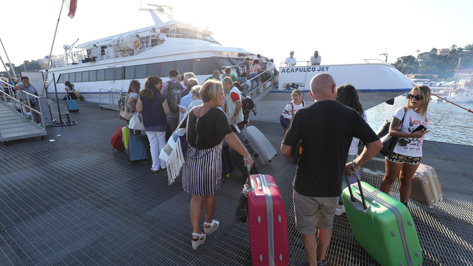 Tote und Verletzte bei Erdbeben in Italien: Junge (11) rettet seinem Bruder (7) das Leben Touristen warten am 22.08.2017 in Casamicciola auf der Insel Ischia (Italien) um die Insel mit der Fähre zu verlassen. Mitten in der Ferienzeit hatte ein Erdbeben die Urlaubsinsel erschüttert. Foto: Stringer/ANSA/AP/dpa +++(c) dpa - Bildfunk+++