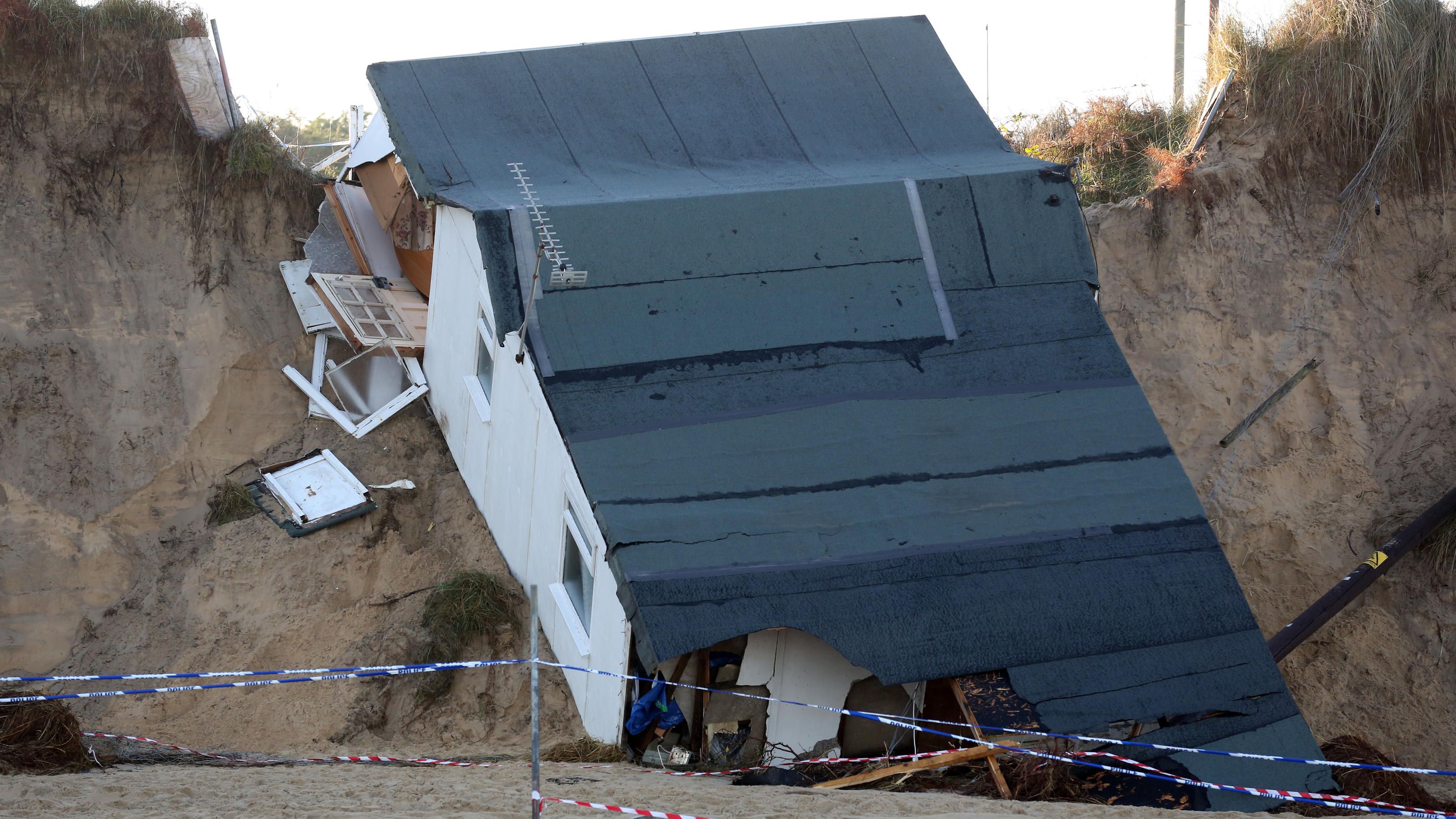 Heftiges Winterwetter in England: 'Mini beast from the east' setzt der Insel zu Tidal surge devastation. General view of a house after it's collapse following a tidal surge along the cliff edge on Hemsby beach in Norfolk last week. Picture date: Wednesday December 11th, 2013. Photo credit should read: Chris Radburn/PA Wire URN:1