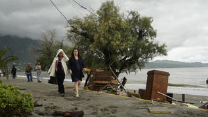 29.09.2018, Griechenland, Kalamata: Zwei Frauen gehen an einem Strand entlang, nachdem der Sturm «Sorbas» vorüberzog. entlang eines Strandes. Der Mittelmeer-Hurrikan «Sorbas» hat an Stärke verloren, nachdem er am Samstagmorgen das griechische Festland erreicht hat. Foto: Nikolia Apostolou/AP/dpa +++ dpa-Bildfunk +++