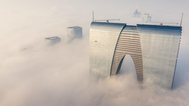 27.11.2018, China, Suzhou: ©/MAXPPP - SUZHOU, CHINA - NOVEMBER 27: Aerial view of a skyscraper in thick fog on November 27, 2018 in Suzhou, Jiangsu Province of China. China Meteorological Administration renewed an orange alert for thick fog on Tuesda