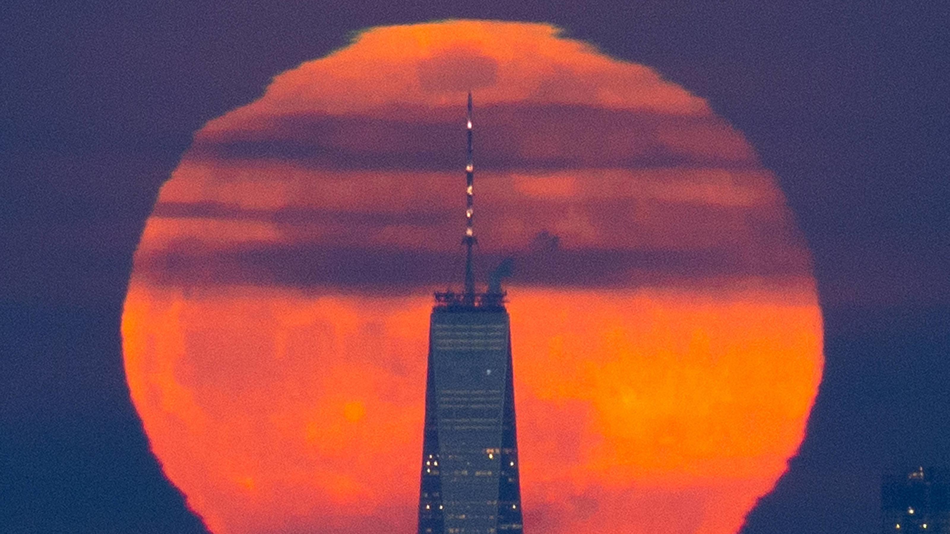 A Super Snow Moon rises behind One World Trade Center and the Manhattan skyline shorty after sunset on February 19, 2019 in New York City. The super snow moon is the second of three supermoon events in the first three months of the year -- a packed l