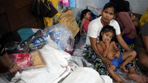 A family gathers at Delpan Evacuation Center after Typhoon Kammuri hit Metro Manila, Philippines, December 3, 2019. REUTERS/Ann Wang