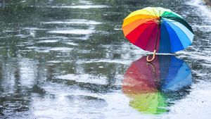 Abstract multi-colored rainbow umbrella on the street