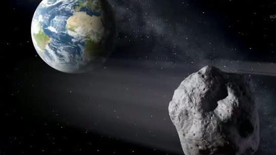 ARCHIV - 01.02.2013, ---: HANDOUT - Die grafische Darstellung zeigt einen Asteroiden (r) beim  Vorbeiflug an der Erde. Asteroiden rasen sehr häufig an der Erde vorbei - meist aber in recht großem Abstand. Näher kommt unserem Planeten zu Anfang des nä