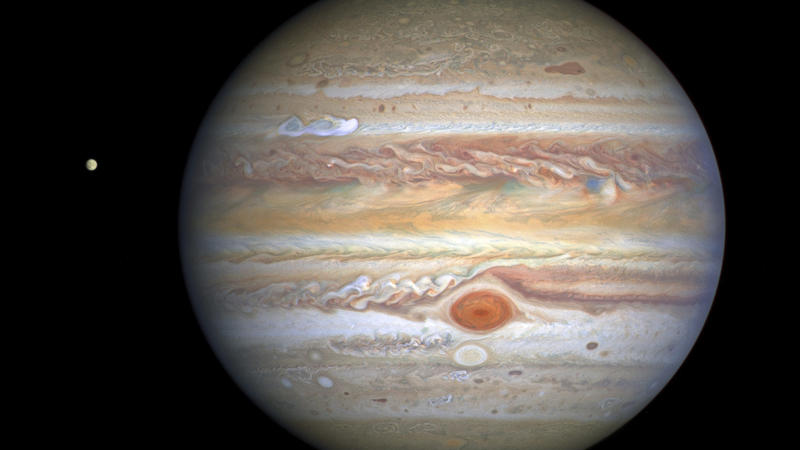 This Aug 25, 2020 image captured by NASA's Hubble Space Telescope shows the planet Jupiter and one of its moons, Europa, at left, when the planet was 406 million miles from Earth. The new photo was released by the Space Telescope Science Institute in