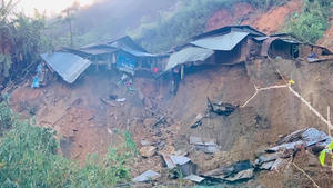 A landslide damages houses in a village in Phuoc Loc district, Quang Nam province, Vietnam Thursday, Oct. 29, 2020. Three separated landslides triggered by Typhoon Molave killed more than a dozen villagers in the province as rescuers scramble to recover more victims. (Lai Minh Dong/VNA via AP)