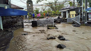 Floodwaters pass by Cagsawa ruins, a famous tourist spot in Daraga, Albay province, central Philippines as Typhoon Goni hit the area on Sunday, Nov. 1, 2020. The super typhoon slammed into the eastern Philippines with ferocious winds early Sunday and about a million people have been evacuated in its projected path, including in the capital where the main international airport was ordered closed. (AP Photo/Alejandro Miraflor)