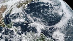 This Tuesday, Nov. 10, 2020, satellite image made available by NOAA shows Tropical Storm Eta at 10:40 a.m. EST in the Gulf of Mexico, Theta, right, and a tropical wave to the south that forecasters say has a good chance of becoming Tropical Storm Iota. (NOAA via AP)