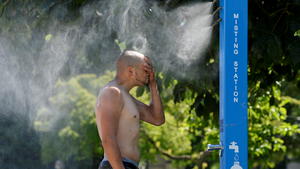 A man cools off at a misting station during the scorching weather of a heatwave in Vancouver, British Columbia, Canada June 27, 2021. REUTERS/Jennifer Gauthier     TPX IMAGES OF THE DAY
