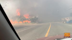 Flames are seen along a street during a wildfire in Lytton, British Columbia, Canada June 30, 2021 in this still image obtained from a social media video on July 1, 2021. 2 RIVERS REMIX SOCIETY/via REUTERS THIS IMAGE HAS BEEN SUPPLIED BY A THIRD PARTY. MANDATORY CREDIT. NO RESALES. NO ARCHIVES. MUST CREDIT "2 RIVERS REMIX SOCIETY / VIMEO.2RMX.CA".