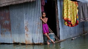 Asma, aged 7, is eagerly waiting for her life to get back to normal after 3 weeks of wait due to severe flooding of Padma river. The photo was taken at Louhajang under Munshiganj district in Bangladesh on 9 August 2020.