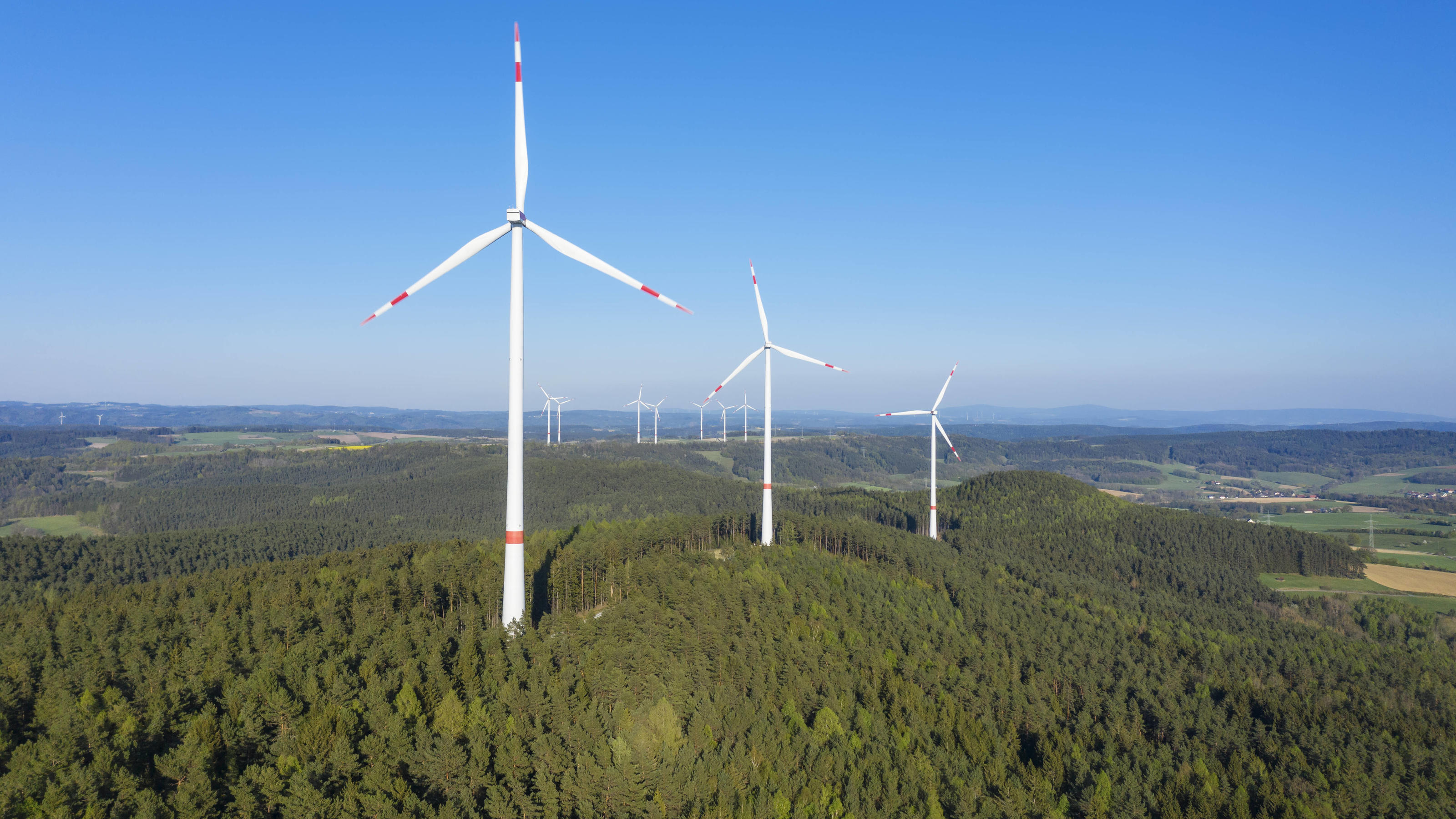  Drone view of forest wind farm in spring RUEF03351