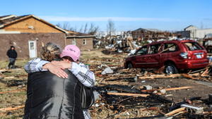Irene Noltner consoles Jody O'Neill outside The Lighthouse, a women and children's shelter that was destroyed by a tornado along with much of the downtown of Mayfield, Kentucky, U.S. December 11, 2021.  Matt Stone/USA TODAY NETWORK via REUTERS NO RESALES. NO ARCHIVES. MANDATORY CREDIT      TPX IMAGES OF THE DAY