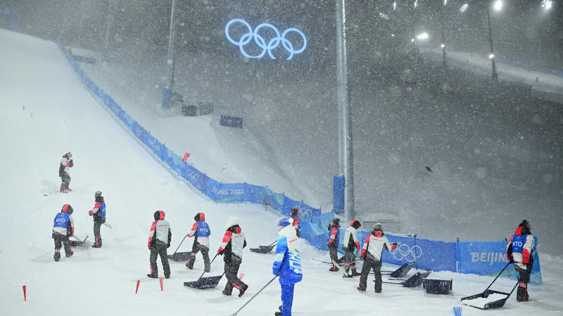  BEIJING WINTER OLYMPICS 2022, Course workers attempt ot clear the run ins as heavy snow falls ahead of the Womens Freestyle Aerials competition, which was subsequently postponed due to bad weather, during the 2022 Beijing Winter Olympic Games, Olymp