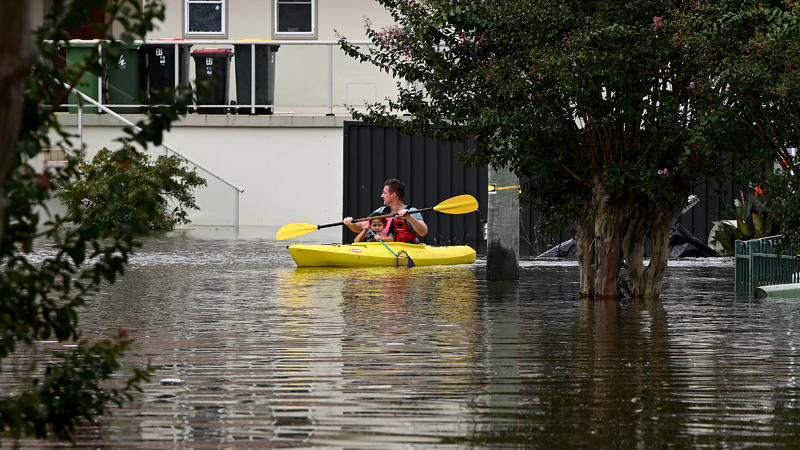  WET WEATHER SYDNEY, Residents paddle through floodwater as a residential properties and roads are submerged in Windsor, north-west of Sydney, Wednesday, March 9, 2022. Meteorologists are warning that communities living across 1000 kilometres of the 