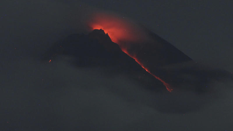 Lava flows down from the crater of Mount Merapi seen from Pakembinangun village in Sleman, Central Java, Thursday, March 10, 2022. Indonesia's Mount Merapi volcano spewed avalanches of hot clouds in eruptions overnight Thursday that forced about 250 
