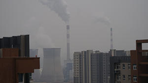 XI'AN, CHINA - DECEMBER 23, 2021 - A view of a coal-fired power plant and buildings in Xi 'an, Shaanxi Province, China, on December 23, 2021. Xi 'an has implemented city-wide closed management of units and communities.
