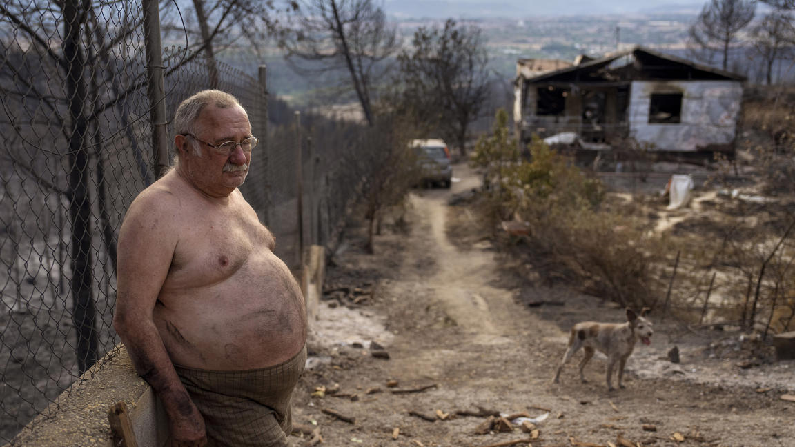 Jordi Villalta, 62, stands next to his house burnt during a wildfire in River Park village, near the town of El Pont de Vilomara, Spain