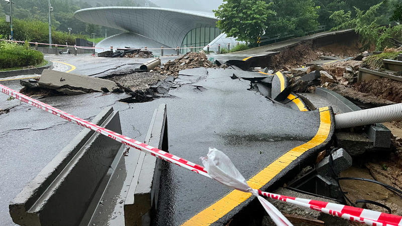   SEOUL, Aug. 9, 2022 -- Photo taken with a mobile phone shows a road damaged by heavy rains in Seoul National University in Seoul, South Korea, Aug. 9, 2022. Eight people were killed and six others went missing as South Korea s metropolitan