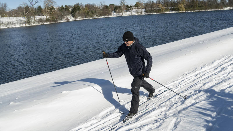 David Frothingham cross country skis in the aftermath of two days of lake-effect snow, along Hoyt Lake in Buffalo, N.Y., Sunday, Nov. 20, 2022. Just south of Buffalo, towns are still working to dig out from the lake-effect storm, but in parts of the 