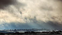 07.12.2022, Nordrhein-Westfalen, Gemünd: Wenige Sonnenstrahlen scheinen durch Wolkenlücken über den Eifelhöhen von Herhahn bei Gemünd aus gesehen. Foto: Oliver Berg/dpa +++ dpa-Bildfunk +++