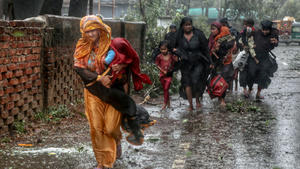 People move from their homes to take shelter in the nearest cyclone shelter at Shah Porir Dwip during the landfall of cyclone Mocha in Teknaf, Bangladesh, May 14, 2023. REUTERS/Jibon Ahmed NO RESALES. NO ARCHIVES     TPX IMAGES OF THE DAY