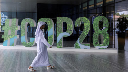 FILE PHOTO: A person walks past a #COP28 sign during The Changemaker Majlis, a one-day CEO-level thought leadership workshop focused on climate action, in Abu Dhabi, United Arab Emirates, October 1, 2023. REUTERS/Amr Alfiky/File Photo