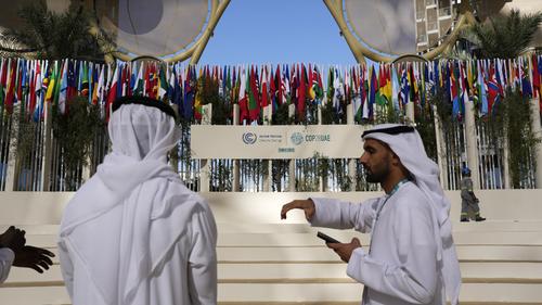People talk in the Al Wasl Dome at Expo City at the COP28 U.N. Climate Summit, Thursday, Nov. 30, 2023, in Dubai, United Arab Emirates. (AP Photo/Rafiq Maqbool)