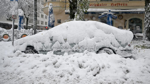 02.12.2023, Bayern, München: Schneemassen liegen auf einem Auto. Schnee und Eis haben im Süden Bayerns auf den Straßen und bei der Bahn für Chaos gesorgt. Foto: Felix Hörhager/dpa +++ dpa-Bildfunk +++