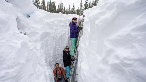 FILE - Working inside a nearly 18-foot-deep snow pit at the UC Berkeley Central Sierra Snow Lab, from left, Shaun Joseph, Claudia Norman, Helena Middleton take measurements of snow temperatures ahead of a weather storm on March 9, 2023, in Soda Springs, Calif. A new study finds the snow deluge in California, which quickly erased a two decade long megadrought, was essentially a once-in-a-lifetime rescue from above. The study authors coined the term â€œsnow delugeâ€ for one-in-20-year heavy snowfalls. (Karl Mondon/Bay Area News Group via AP, File)