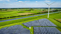 WAALWIJk - Drone photo of a solar park with solar panels and wind turbines from eneco are in the landscape in nature with electricity pylons in the foreground / 230424