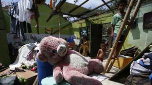 A teddy bear lies on a chair for drying inside a roofless damaged house two days after the onslaught of Typhoon Rammasun (locally named Glenda) in Gumaca, Quezon province south of Manila, July 18, 2014. The typhoon heading towards southern China has strengthened as it approaches the provinces of Hainan and Guangdong and is now a super typhoon, the government said on Friday, ordering that all efforts be made to prevent loss of life. Typhoon Rammasun, which has already killed at least 54 people in the Philippines, is expected to make landfall between the two provinces on Friday afternoon, the National Meteorological Centre said on its website.  REUTERS/Erik De Castro   (PHILIPPINES - Tags: DISASTER ENVIRONMENT)