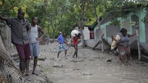 People walk through a mudslide caused by Tropical Storm Erika in Carries, Haiti, August 29, 2015. Erika, a tropical storm that killed 20 people on the Caribbean island of Dominica and at least one person in Haiti, fell apart on Saturday over eastern Cuba, the U.S. National Hurricane Center said. REUTERS/Andres Martinez Casares