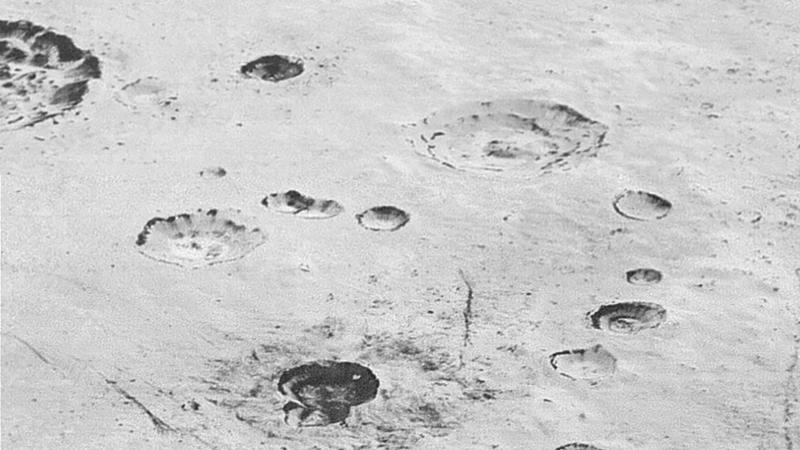 HANDOUT - Layered Craters and Icy Plains: This highest-resolution image from NASA?s New Horizons spacecraft reveals new details of Pluto?s rugged, icy cratered plains, including layering in the interior walls of many craters. "Impact craters are natu