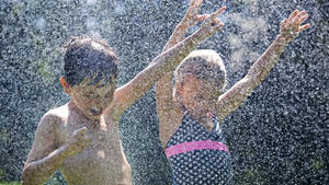 Quebec Hot Weather. Estella Willis, right, and Joshua Boardman beat the heat as they cool down under a garden hose in the town of Hudson, Que., near Montreal, Sunday, July 17, 2011. (AP Photo/The Canadian Press, Graham Hughes) URN:11215022 |