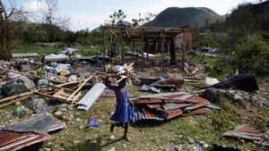 A girl carrying wood walks near debris after Hurricane Matthew passed, in Camp Perrin, Haiti, October 8, 2016. REUTERS/Andres Martinez Casares     TPX IMAGES OF THE DAY     