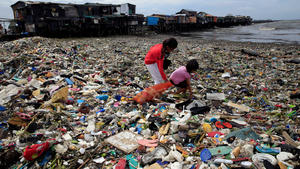 Children take advantage of the gloomy weather to collect washed up rubbish brought by crashing waves due to strong winds of Super Typhoon Haima, local name Lawin, which they will sell at junk shops along the coastal areas, in metro Manila, Philippines October 20, 2016. REUTERS/Romeo Ranoco