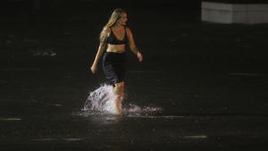 A woman wades through a flooded Water St. in downtown Mobile, Ala., during Hurricane Nate, Sunday, Oct. 8, 2017, in Mobile, Ala. (AP Photo/Brynn Anderson) |